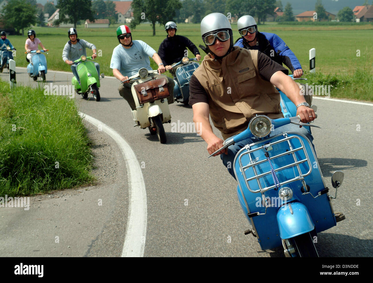 (FILE) - The picture shows Italian Vespa motor scooter enthusiasts during a joyride in Bad Waldsee-Osterhofen, Germany, 25 July 2004. Photo: Rolf Schultes Stock Photo