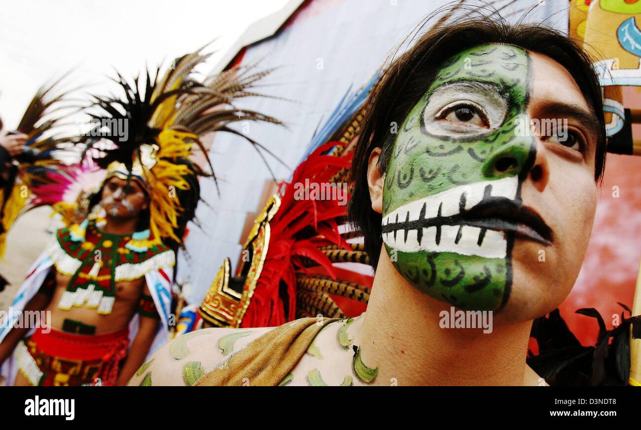 Men dressed in traditional costumes and sporting traditional Native American body paint designs