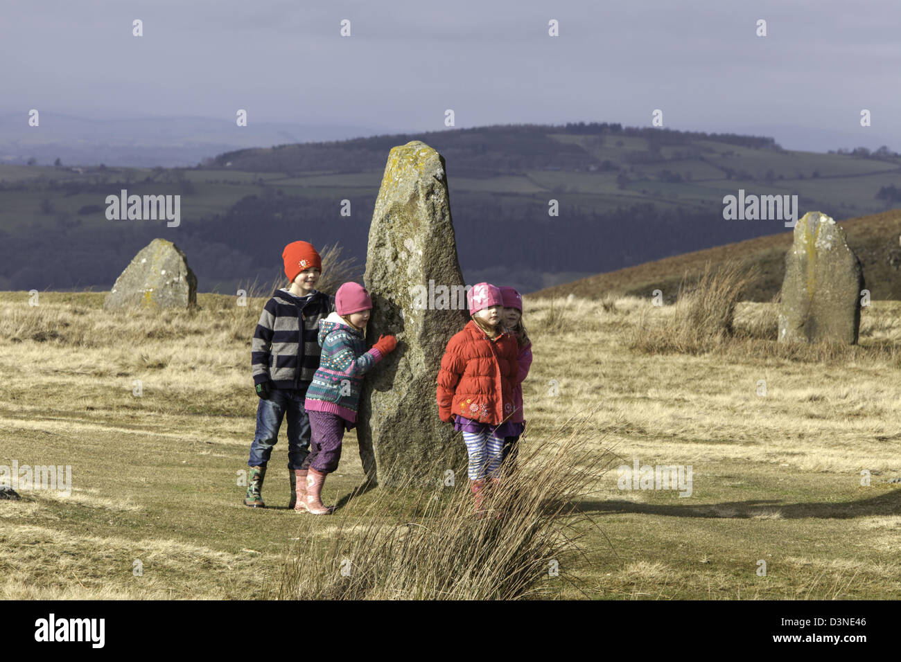 Children playing at Mitchell's Fold Stone Circle, Stapeley Hill Shropshire, England, UK Stock Photo