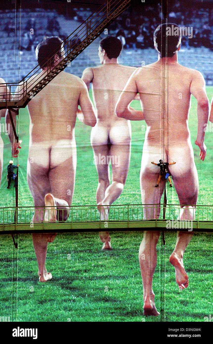 Professional industry climbers put up posters with naked men on the  exterior of the giant gas metre in Oberhausen, Germany, Tuesday 09 May  2006. 16 giant posters make up the 2000 square