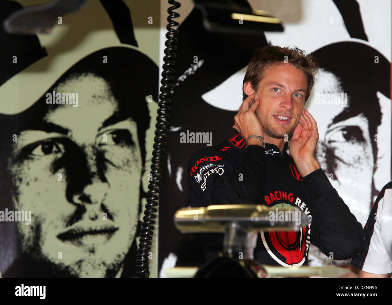 British Formula One pilot Jenson Button of Honda Racing F1 team protects his ears in his garage during the practice session to the 2006 FORMULA 1 Grand Prix of Spain at the race track Circuit de Catalunya in Montmelo near Barcelona, Spain, Saturday, 13 May 2006. The 2006 FORMULA 1 Grand Prix of Spain takes place on Sunday. Photo: Gero Breloer Stock Photo