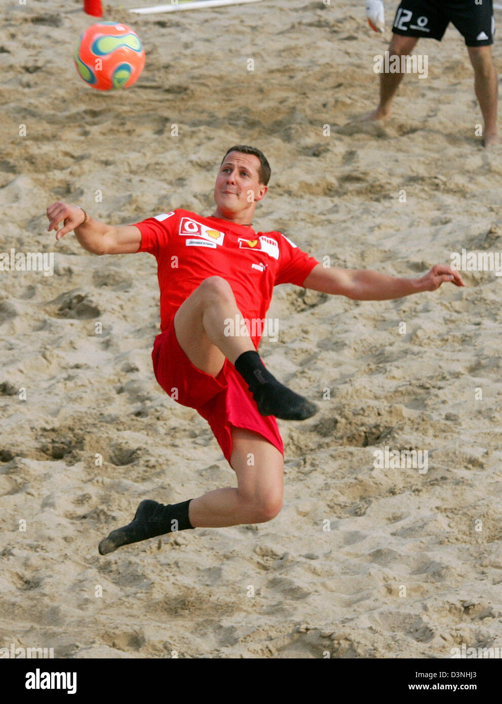 German Formula One driver Michael Schumacher of Scuderia Ferrari F1 team performs a overhead kick during a beach soccer match at the F1 race track Circuit de Catalunya in Montmelo near Barcelona, Spain, Thursday 11 May 2006. The Grand Prix of Spain takes place on Sunday. Photo: Gero Breloer Stock Photo