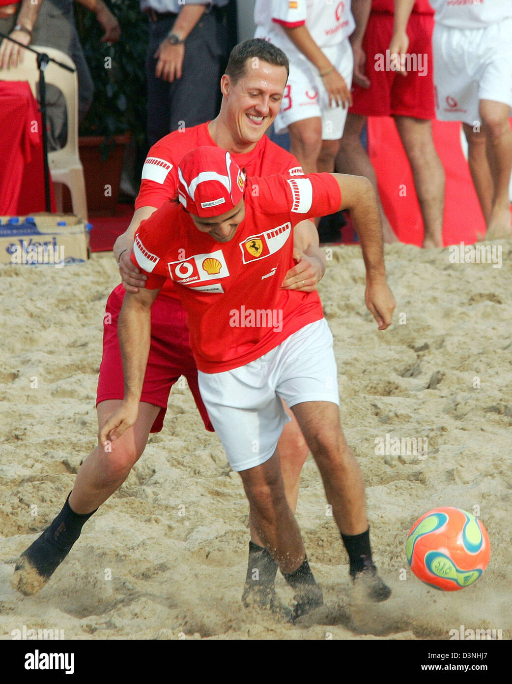 German Formula One driver Michael Schumacher (background) of Scuderia Ferrari F1 team and his Brazilian team mate Felipe Massa challenge during a beach soccer match at the race track Circuit de Catalunya in Montmelo near Barcelona, Spain, Thursday 11 May 2006. The Grand Prix of Spain takes place on Sunday. Photo: Gero Breloer Stock Photo