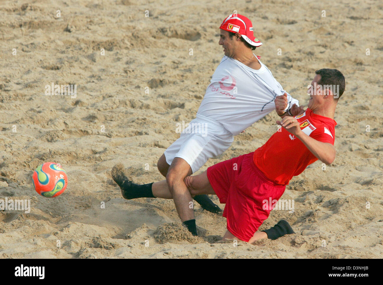 German Formula One driver Michael Schumacher (R) of Scuderia Ferrari F1 team and his Brazilian team mate Felipe Massa challange each other during a beach soccer match at the race track Circuit de Catalunya in Montmelo near Barcelona, Spain, Thursday 11 May 2006. The Grand Prix of Spain takes place on Sunday. Photo: Gero Breloer Stock Photo