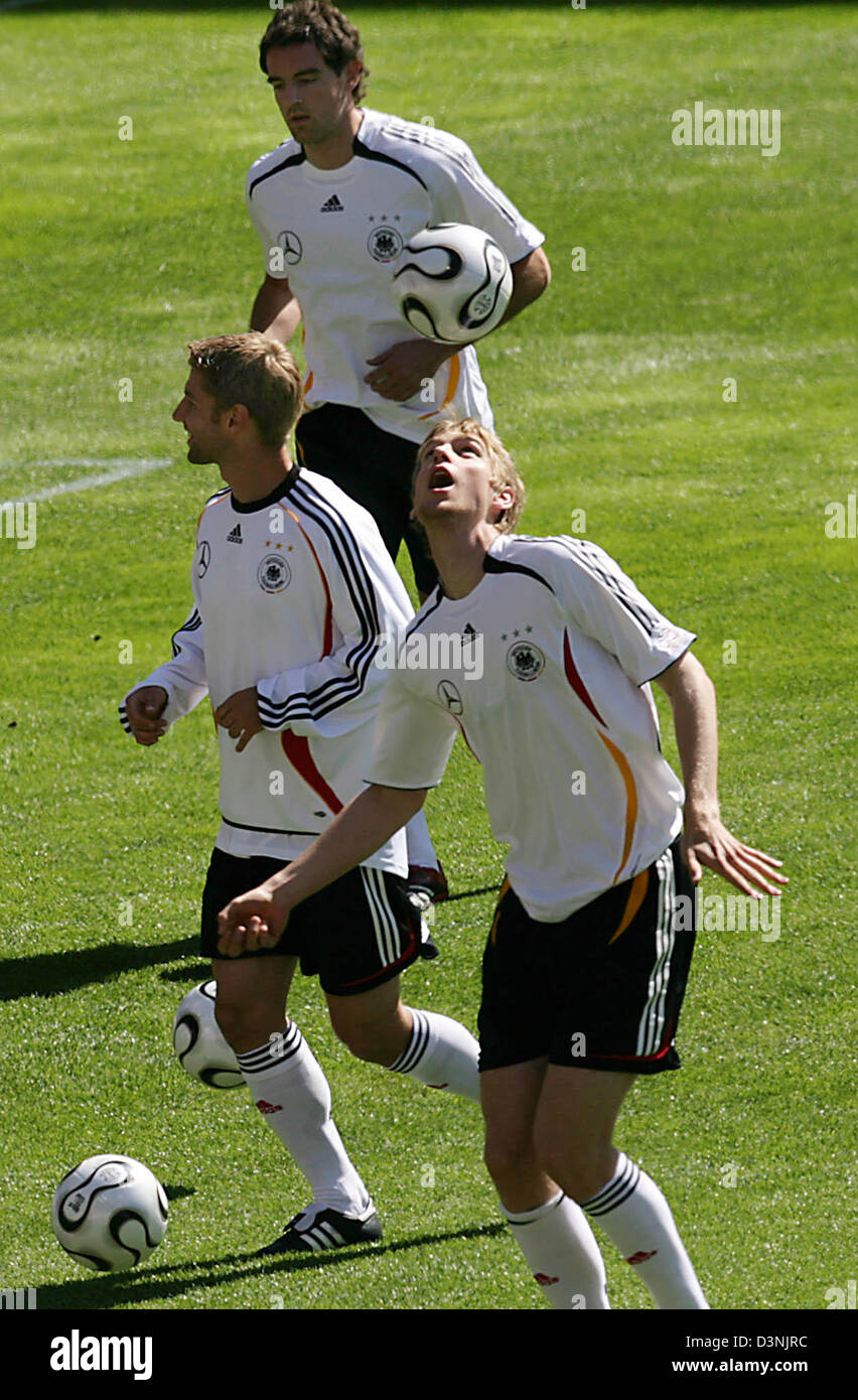 German national soccer team players Christoph Metzelder, Thomas Hitzlsperger  and Per Mertesacker (back to front) are in action during a training session  in Geneva, Switzerland, Wednesday, May 24, 2006. The German team
