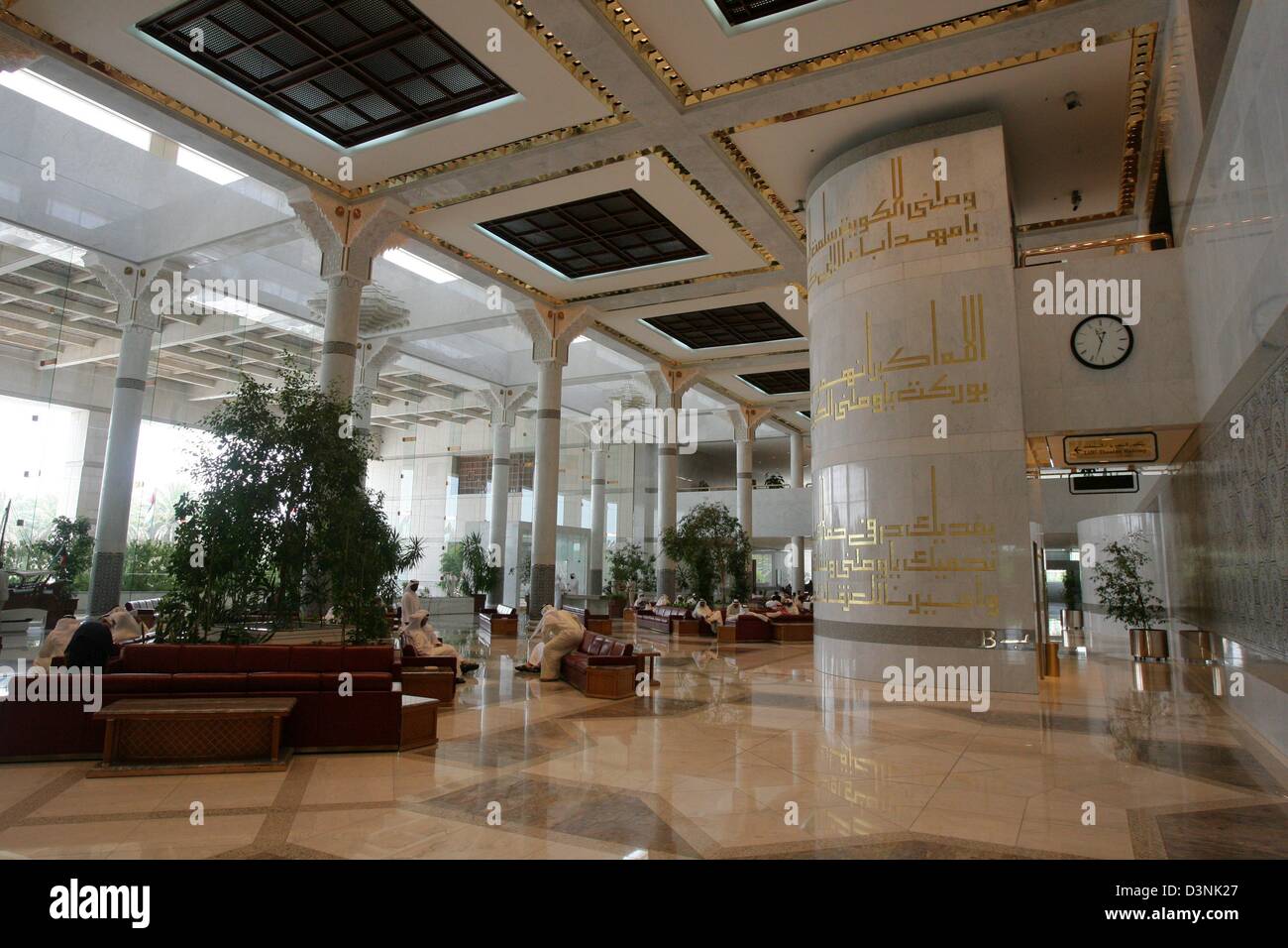 Men in traditional clothing sit in one of the many lobbies of the