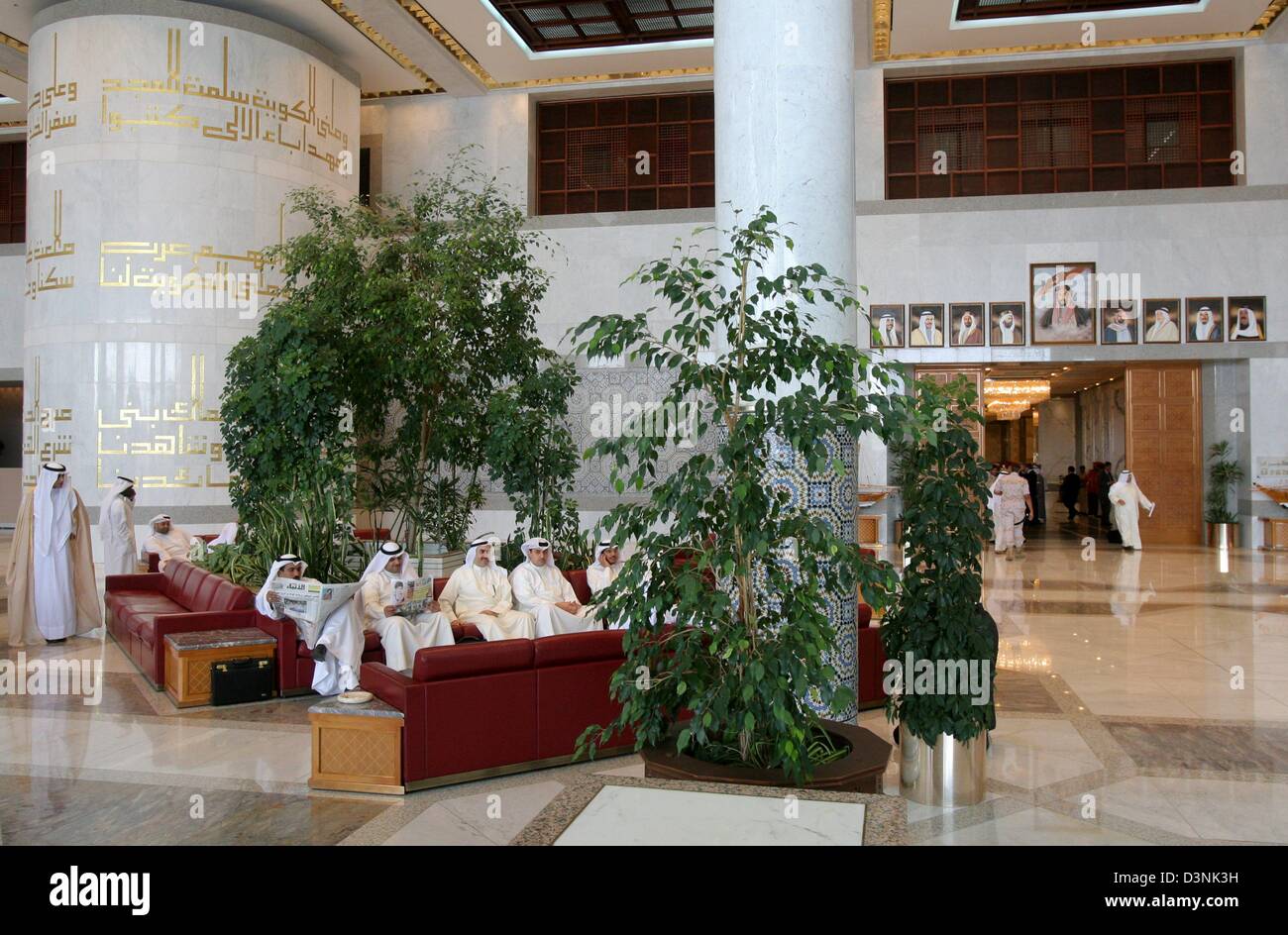 Men in traditional clothing sit in the lobby of the spacious and