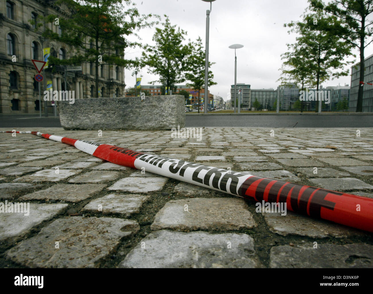 A police barrier tape lies on the ground, marking the site of crime where a 16-years old boy committed an amok run, Berlin, Germany, Saturday 27 May 2006. The boy stabbed 28 persons after the light show which was part of the opening of the new central station in Berlin Friday night. Six of his victims were severely injured. Photo: Wolfgang Kumm Stock Photo