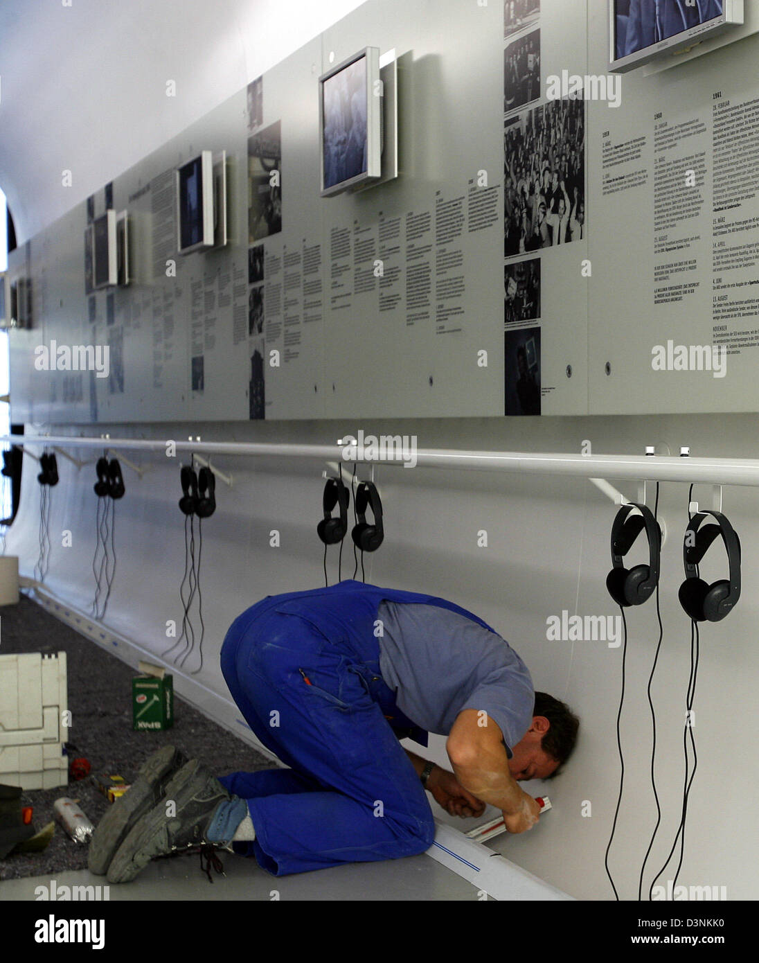 An electrician installs headphones to an information desk of the new German Television Museum at the Potsdamer square in Berlin, Germany, Tuesday, 30 May 2006. The permanent exhibition gives a view on 53 years of television history in both parts of Germany. After 20 years of preperations the museum opens its gates in the film house of the Sony Centre on Thursday, 1 June. Photo: Wol Stock Photo