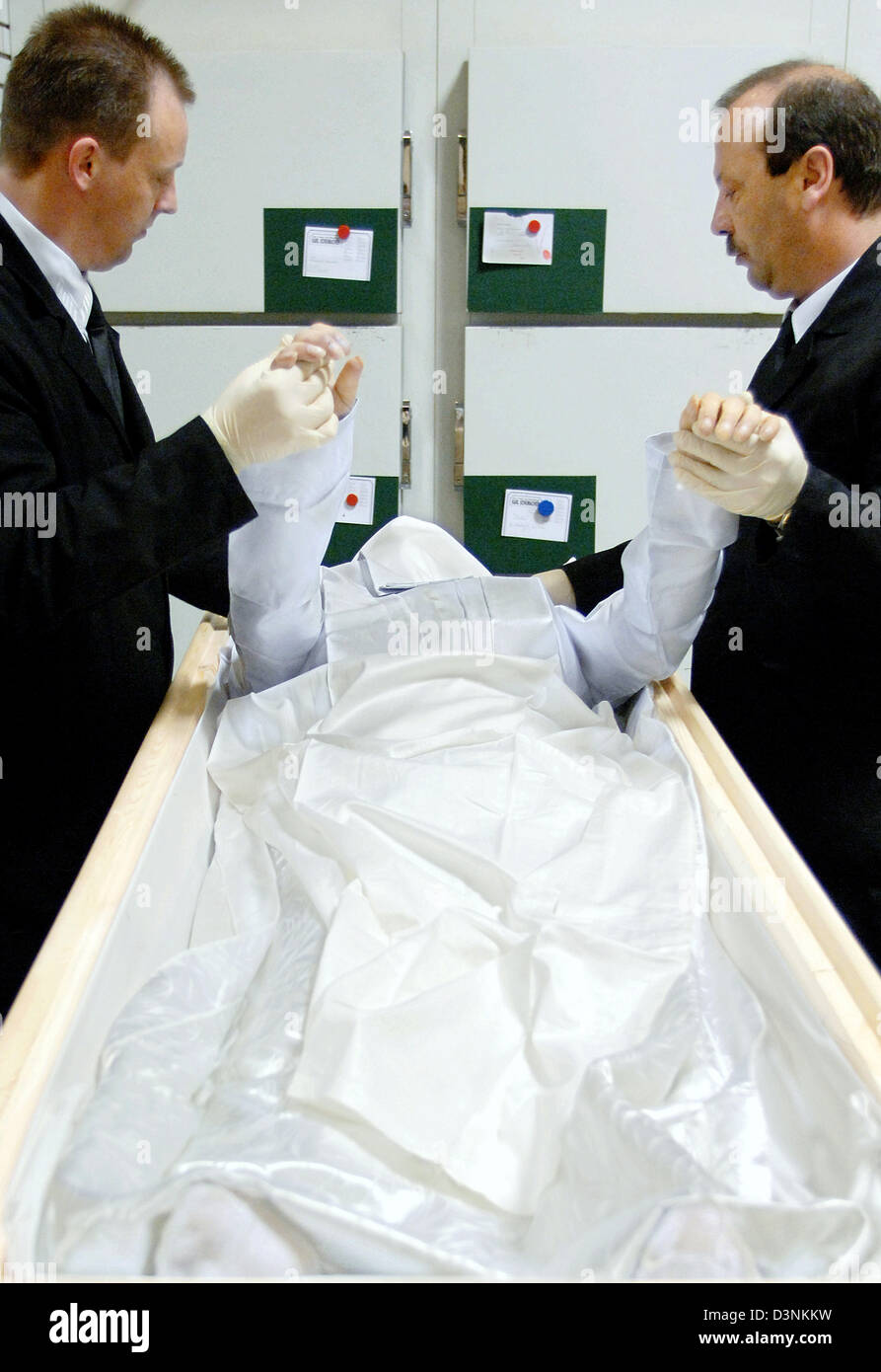 Employees of the funeral undertaker Karl Schumacher prepare a corpse