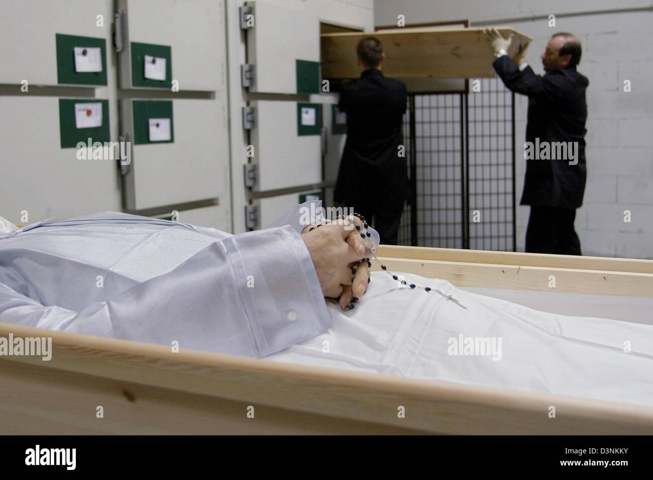 Employees of the funeral undertaker Karl Schumacher prepare a corpse