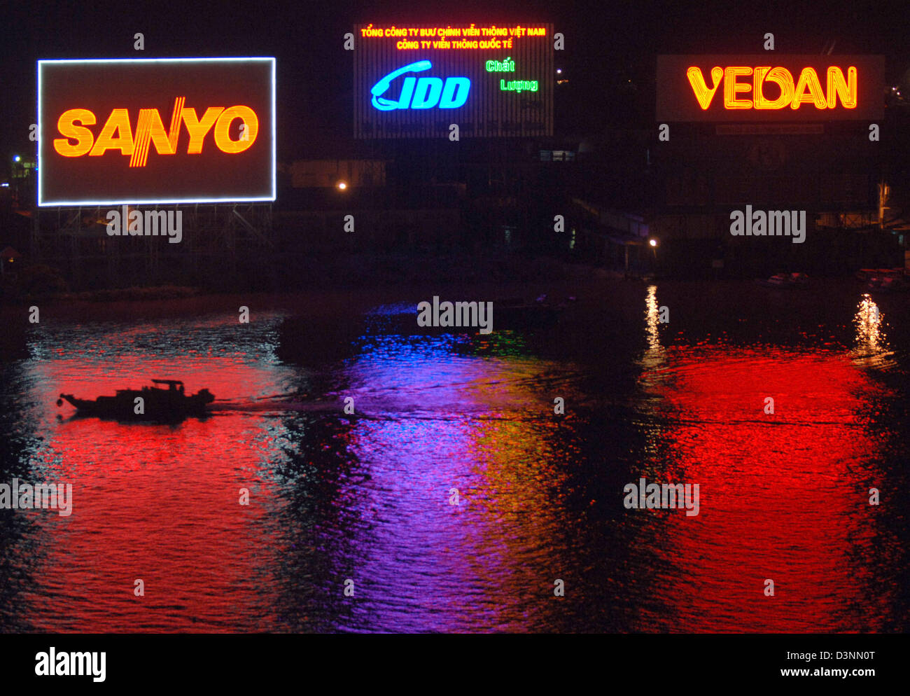 dpa file) - Neon signs of the companies Sanyo, Ido and Vedan illuminate the  Saigon River at night in Saigon,Vietnam, 28 February 2006. Photo: Christine  Kokot Stock Photo - Alamy
