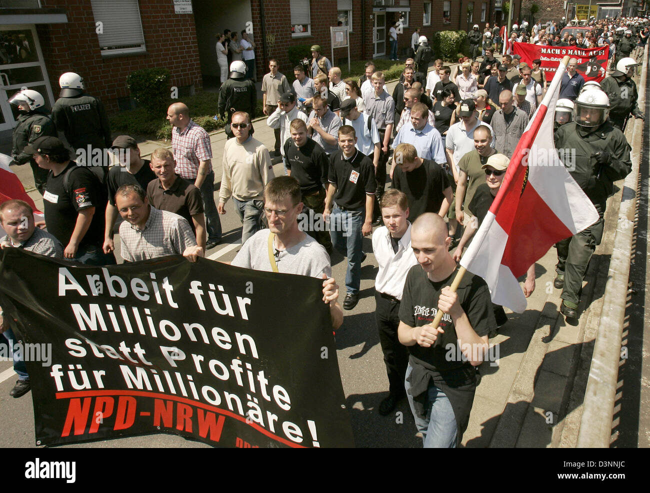 Neo-Nazis march with their flags in downtown Gelsenkirchen, Germany, Saturday, 10 June 2006. The rally of circa 200 rightist-extremist party NPD supporters was permitted by the Federal Constitutional Court only Friday, 9 June after the higher administrative court Muenster had prohibited it. The judges in Muenster reasoned their decision with a massive breach of the public security. Stock Photo