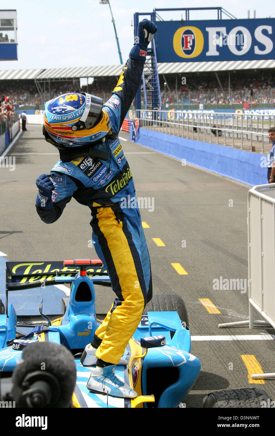 Spanish Formula One driver Fernando Alonso of the Renault F1 team  celebrates after winning the British Grand Prix at the Silverstone race  track in Northamptonshire, Great Britain, Sunday, 11 June 2006. Photo: