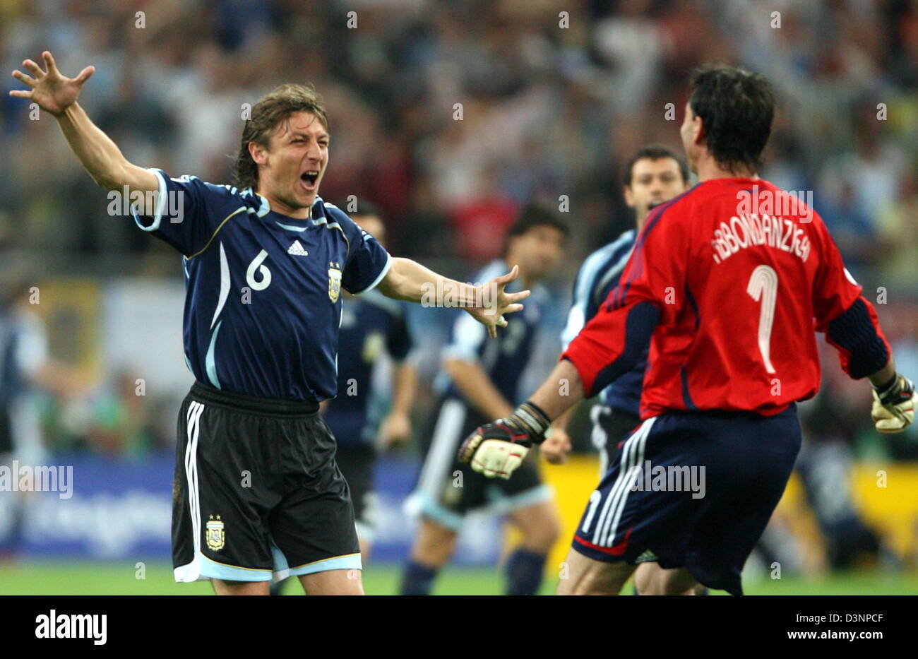 Argentinian Player Gabriel Heinze (L) celebrates with goalkeeper Roberto Abbondanzieri after his team scored the 1:0 lead agaist Serbia and Montenegro during the group C match of 2006 FIFA World Cup between Argentina and Serbia and Montenegro in Gelsenkirchen on Friday, 16 June, 2006. DPA/ROLAND WEIHRAUCH +++ Mobile Services OUT +++ Please refer to FIFA's Terms and Conditions Stock Photo