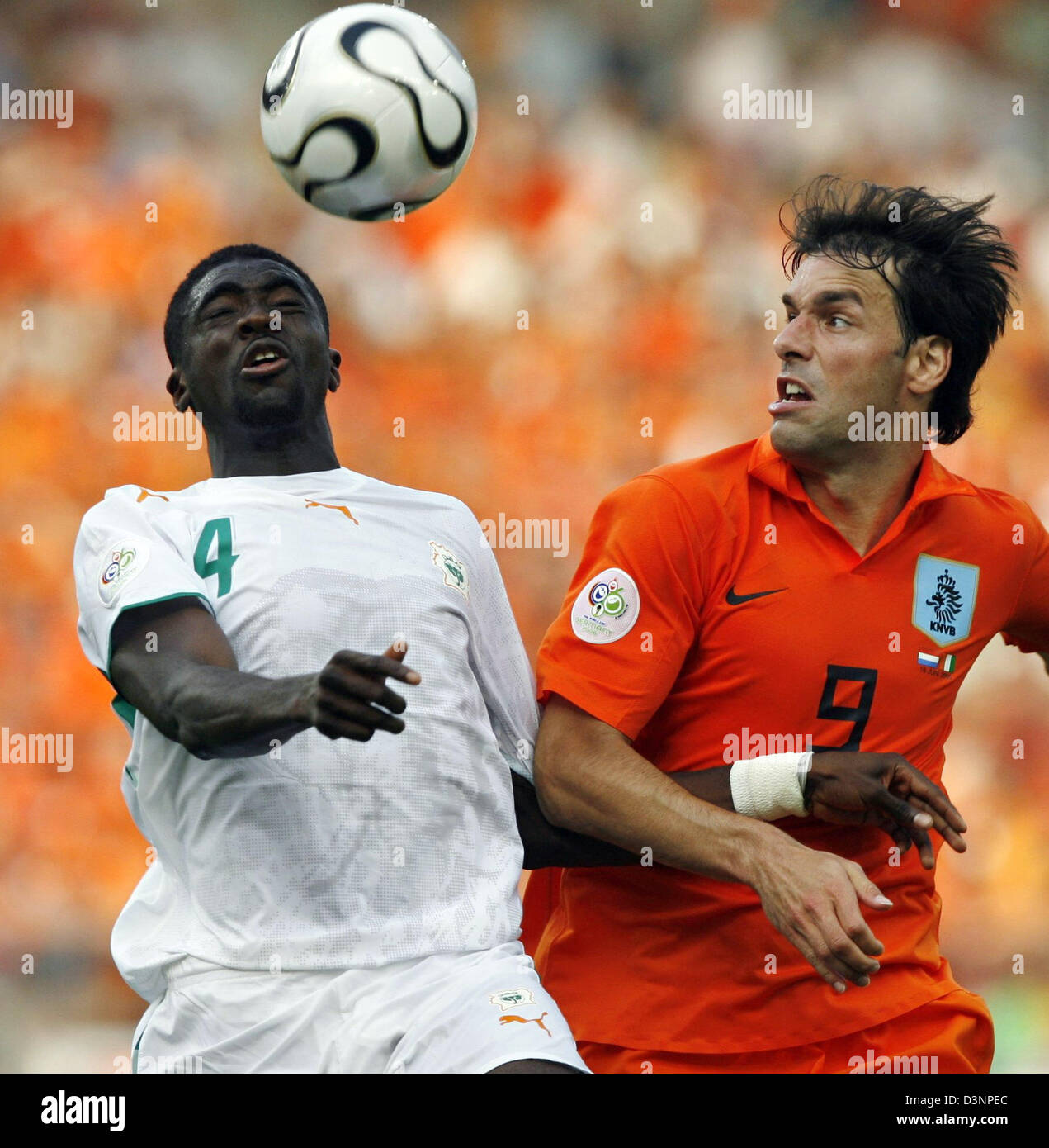 Kolo Toure from Ivory Coast (L) heads the ball before Dutch Ruud van