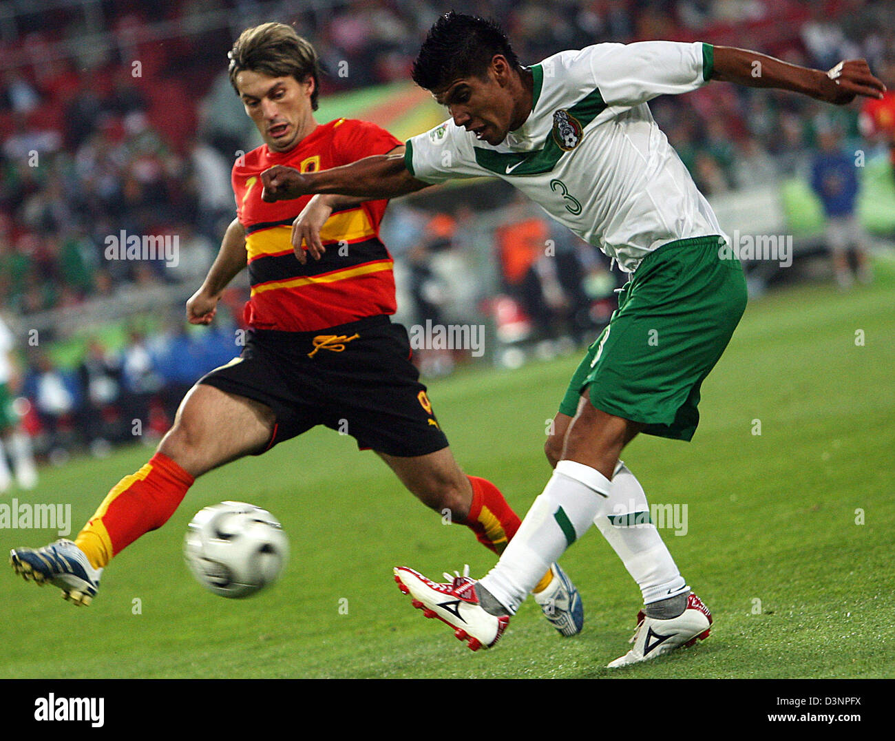 Mexican player Carlos Salcido (R) vies with Figueiredo (L) from Angola during the group D preliminary match of the 2006 FIFA World Cup between Mexico and Angola in Hanover, Germany, Friday, 16 June 2006. Photo: CARMEN JASPERSEN +++ Mobile Services OUT +++ Please also refer to FIFA's Terms and Conditions. Stock Photo