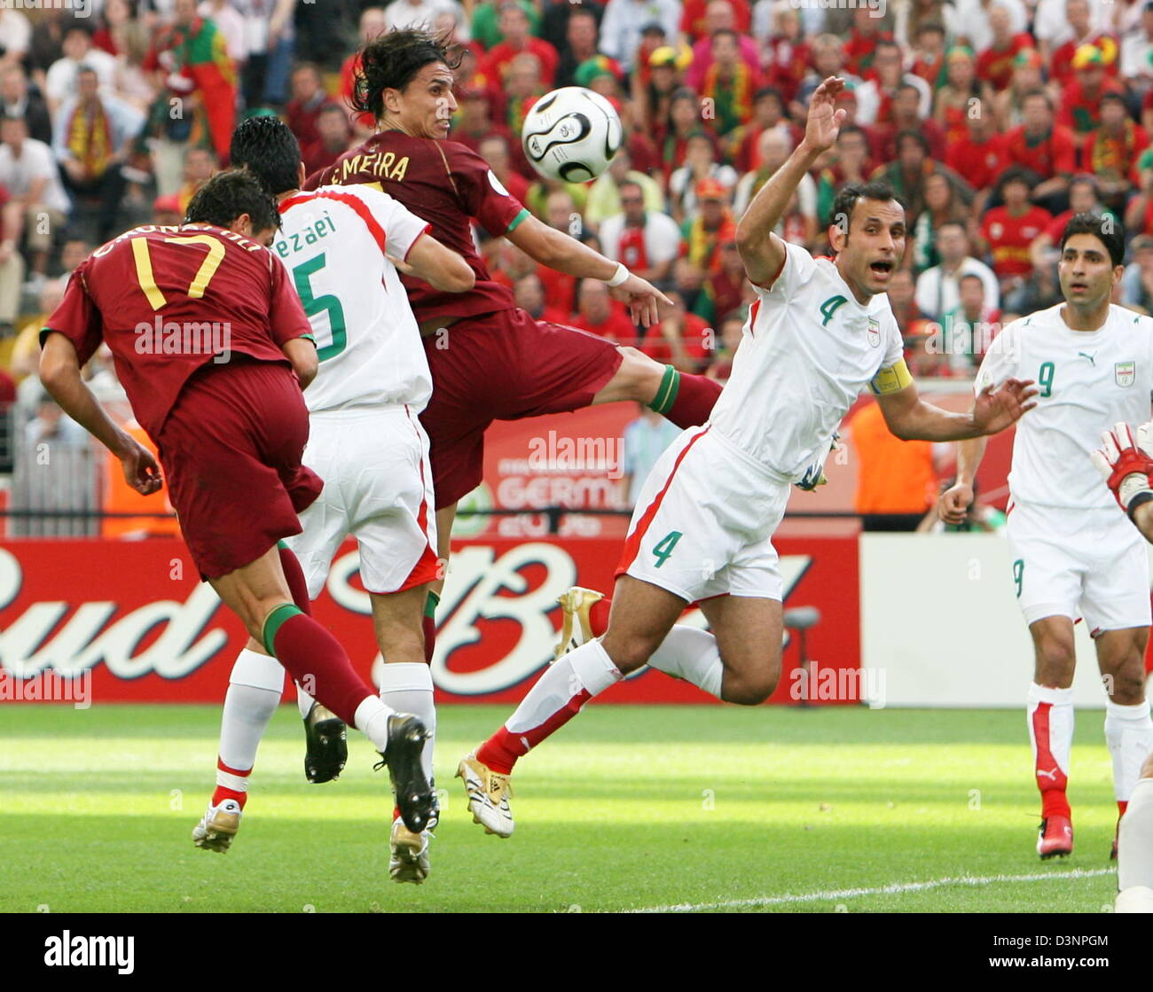 Cristiano Ronaldo (L) of Portugal takes a header on the goal during the 2006 FIFA World Cup group D match of Portugal vs Iran in Frankfurt, Germany, Saturday 17 June 2006. Behind him (L-R) Rahman Rezaei of Iran, Fernando Meira of Portugal, and Yahya Golmohammadi of Iran fight for the ball. DPA/BERND WEISSBROD+++ Mobile Services OUT +++ Please refer to FIFA's Terms and Conditions ++ Stock Photo