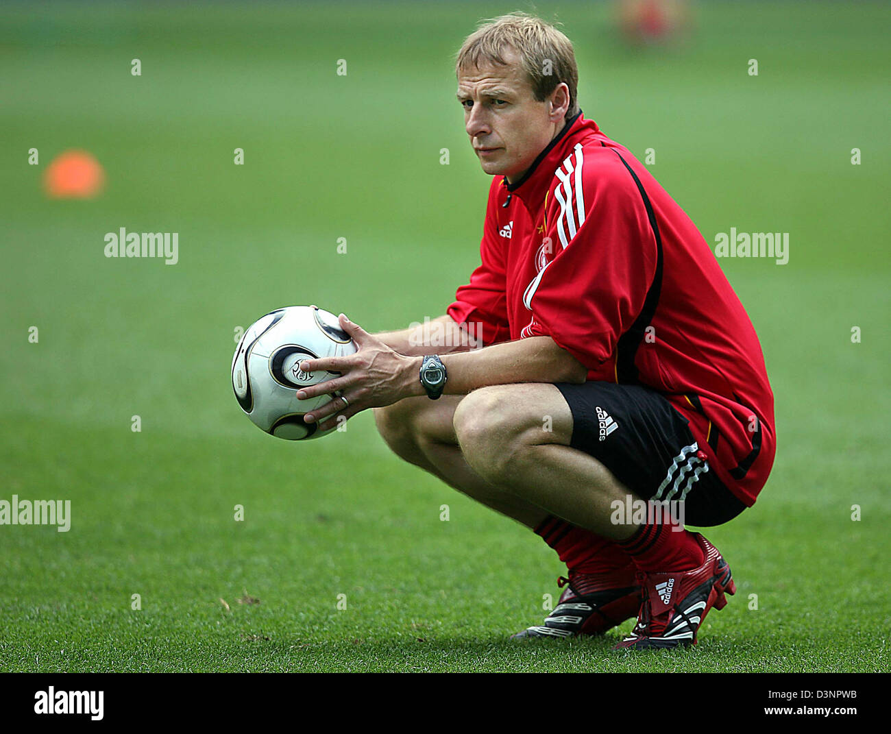 Germany's team coach Juergen Klinsmann watches the players during the training session in Berlin, Monday, 19 June 2006. The German national soccer team prepares for the third group A match against Ecuador on Tuesday, 20 June 2006, in Berlin. Photo: OLIVER BERG Stock Photo