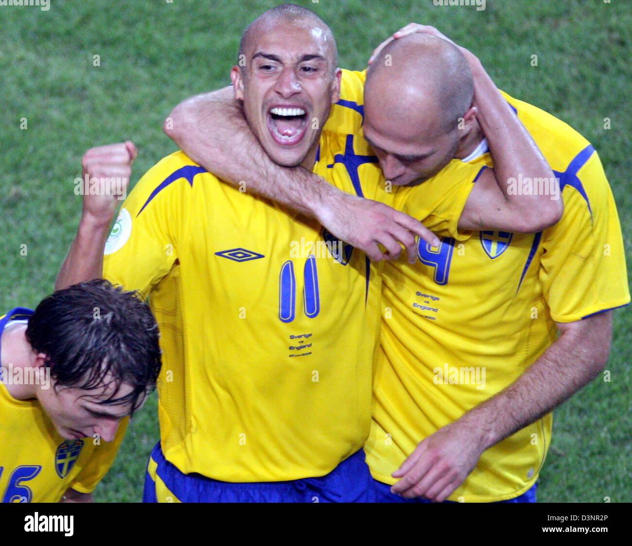 Henrik Larsson (C) from Sweden is celebrated by teammates Kim Kallstrom (L)  and Freddie Ljungberg (R) after scoring the 2:2 draw during the group B  match of 2006 FIFA World Cup between