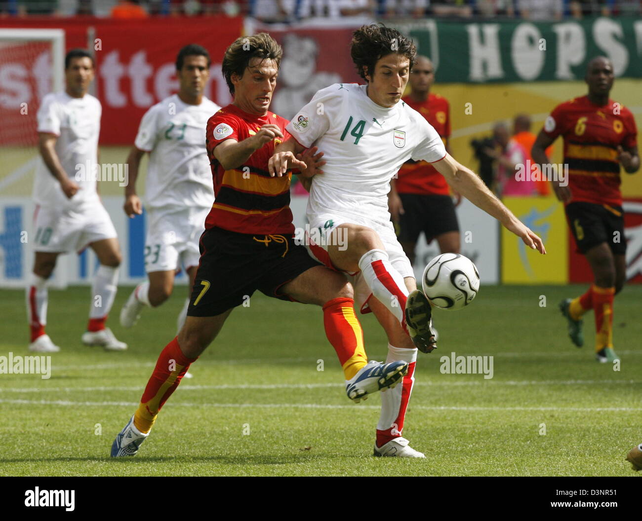 Figueiredo (L) of Angola vies for the ball with Andranik Teymourian of Iran during the group D preliminary match of 2006 FIFA World Cup Iran vs. Angola at the FIFA World Cup stadium in Leipzig, Germany, Wednesday, 21 June 2006. DPA/WOLFGANG KUMM +++ Mobile Services OUT +++ Please refer to FIFA's Terms and Conditions Stock Photo