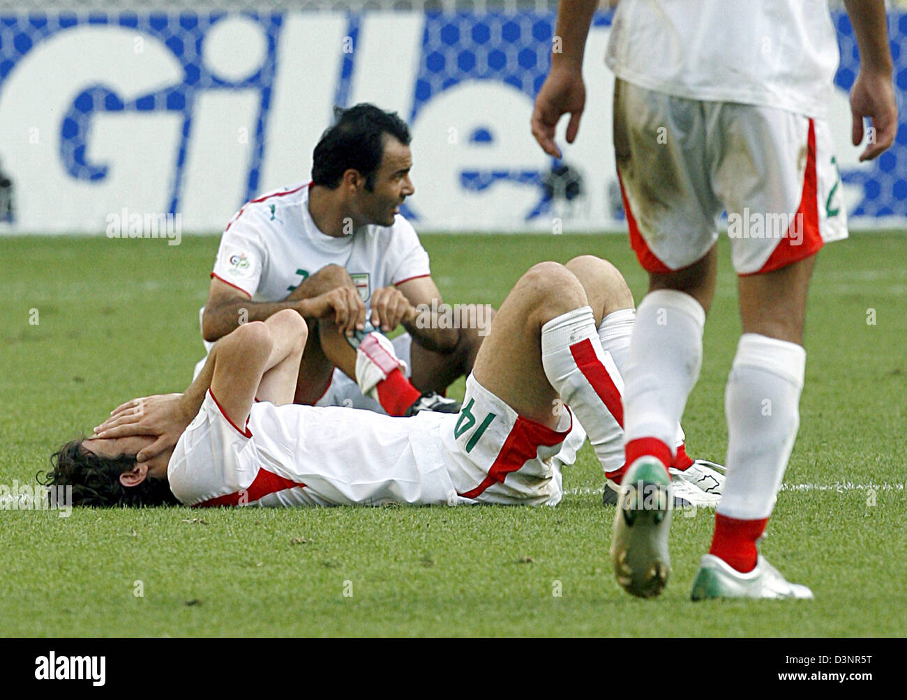 Andranik Teymourian (L) and Sohrab Bakhtiarizade of Iran lay on the ground after the group D preliminary match of 2006 FIFA World Cup Iran vs. Angola at the FIFA World Cup stadium in Leipzig, Germany, Wednesday, 21 June 2006. The match ended with a 1-1 tie. DPA/WOLFGANG KUMM +++ Mobile Services OUT +++ Please refer to FIFA's Terms and Conditions. Stock Photo