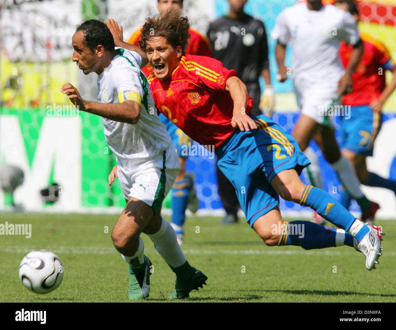 Michel Salgado (R) of Spain and Sami Al Jaber of Saudi Arabia during the 2006 FIFA World Cup group H match of Saudi Arabia vs Spain in Kaiserslautern, Germany, Friday 23 June 2006. DPA/ARNE DEDERT +++ Mobile Services OUT +++ Please also refer to FIFA's Terms and Conditions. +++(c) dpa - Bildfunk+++ Stock Photo