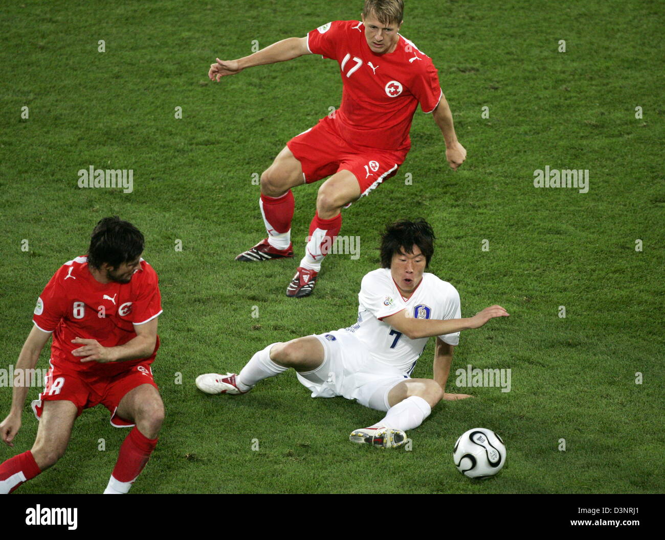 Swiss internationals Raphael Wicky (L) and Christoph Spycher concentrate on Ji Sung Park (bottom) from South Korea during the 2006 FIFA World Cup group G match of Switzerland vs South Korea in Hanover, Germany, Friday, 23 June 2006. DPA/RAINER JENSEN +++ Mobile Services OUT +++ Please also refer to FIFA's Terms and Conditions. +++(c) dpa - Bildfunk+++ Stock Photo