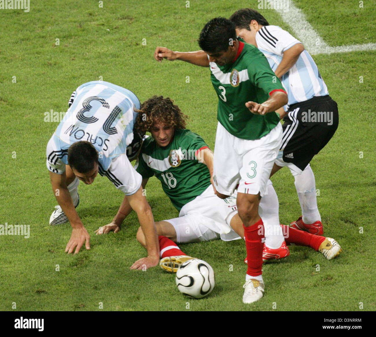 (L-R) Lionel Scaloni of Argentina vies for the ball with Andres Guardado (C) and Juan Sorin of Mexico during the 2006 FIFA World Cup Round of 16 match Argentina vs Mexico at the FIFA World Cup stadium in Leipzig, Germany, Saturday 24 June 2006. DPA/JENS WOLF +++ Mobile Services OUT +++ Please refer to FIFA's Terms and Conditions. +++(c) dpa - Bildfunk+++ Stock Photo