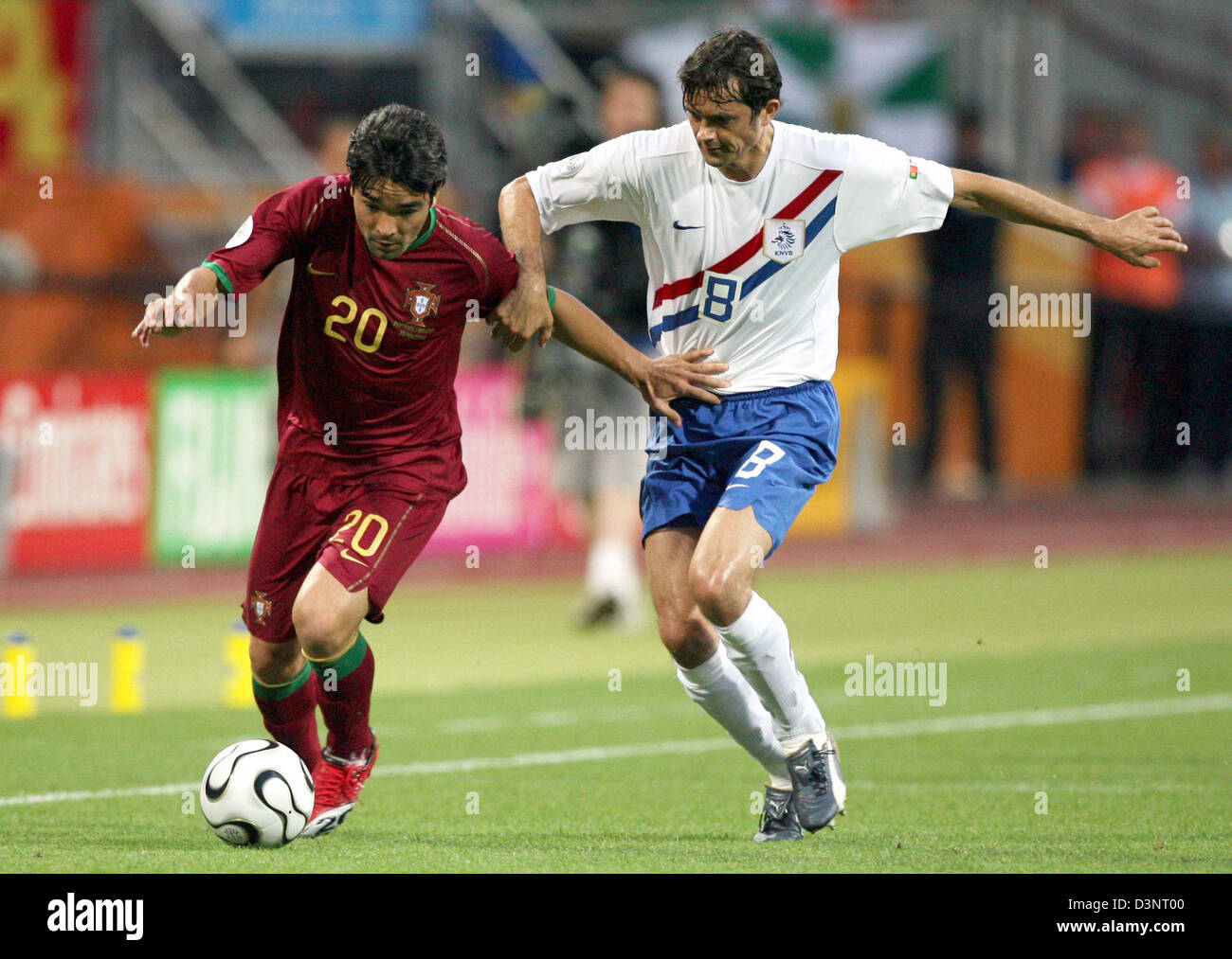 Portugal's Deco (L) fights for the ball with Dutch Phillip Cocu