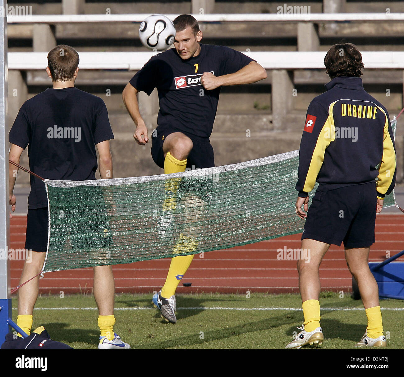 Ukraine national soccer star Andriy Shevchenko (C) plays soccer tennis with  two teammates during a training session in Potsdam, Germany, Wednesday, 28  June 2006. Ukraine faces Italy in the upcoming FIFA World