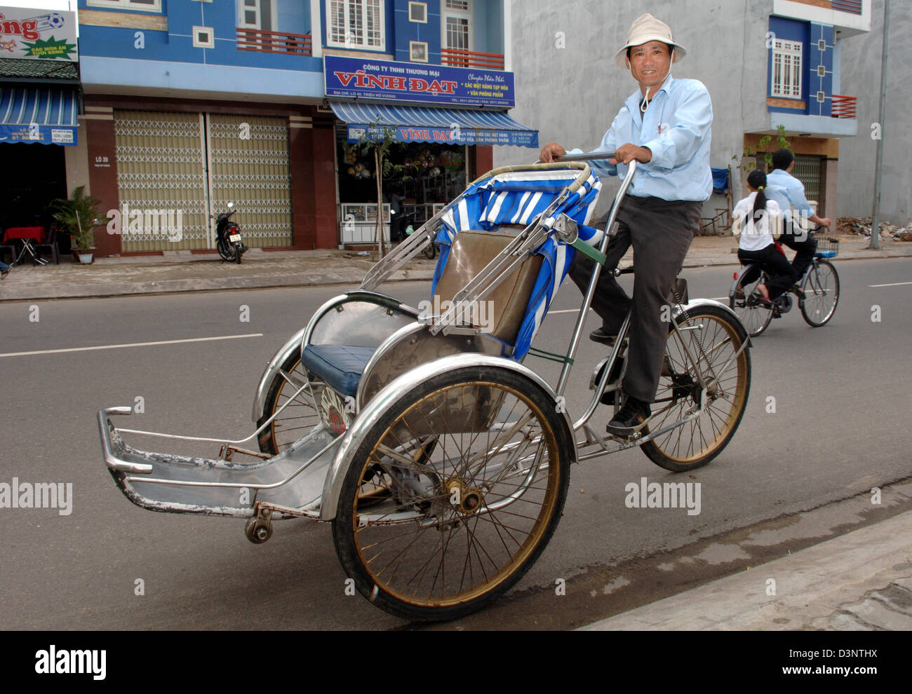 A rickshaw rider sits on his vehicle in Da Nang, Vietnam, 24 February ...