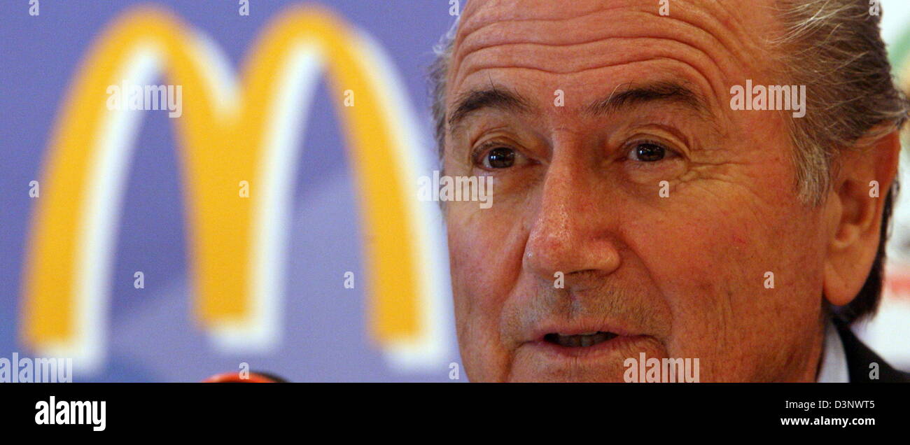 FIFA president Joseph S. Blatter sits in front of the logo of fast food chain McDonald's at a press conference in Berlin, Germany, Saturday, 08 July 2006. The topic of the event was the sponsoring of the World Cup by the fast food chain. Photo: Tim Brakemeier Stock Photo