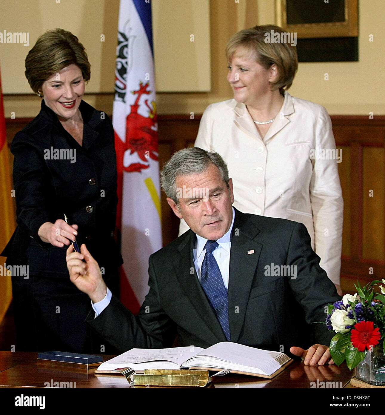 German Chancellor Angela Merkel (R) watches U.S. President George W