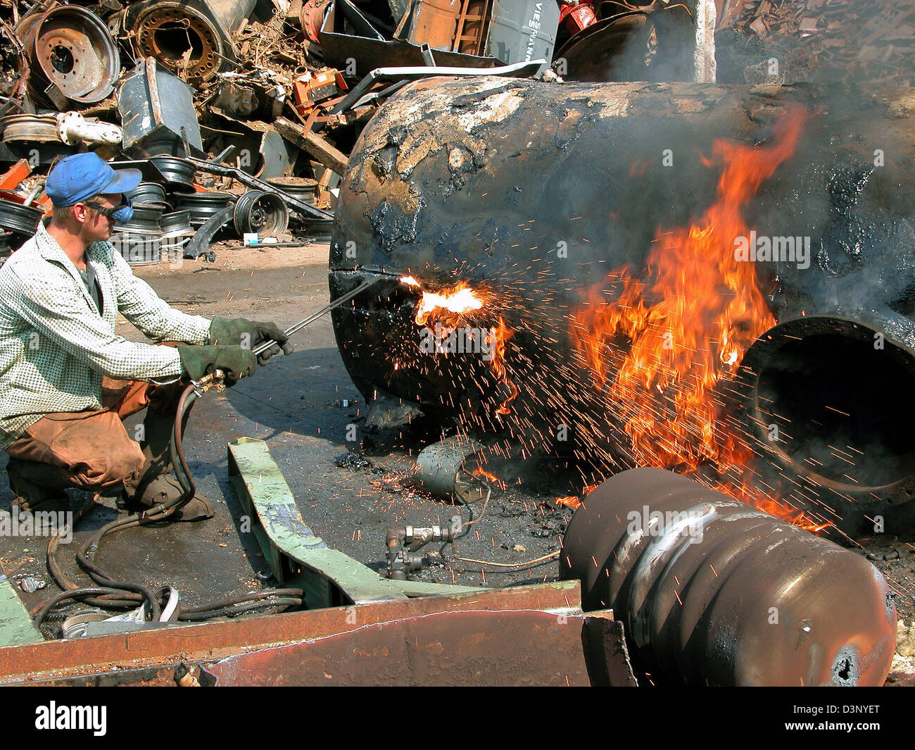 A welder cuts an old tank into several parts on a junkyard in Stuttgart, Germany, Friday, 12 May 2006. Photo: Juergen Effner Stock Photo