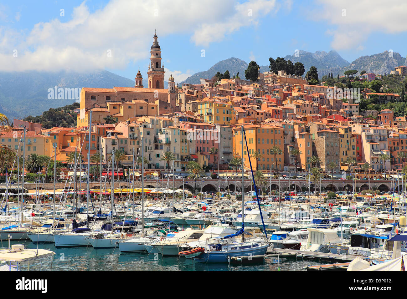 View on colorful houses, church and marina with yachts and boats in Menton - town on French Riviera in France. Stock Photo