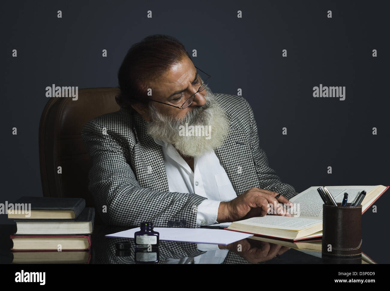 Critic writing review on a book Stock Photo