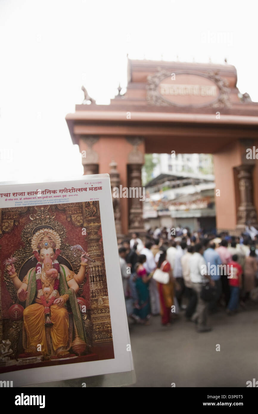 Poster of Lord Ganesh with crowd at a temple in the background, Mumbai,  Maharashtra, India Stock Photo - Alamy