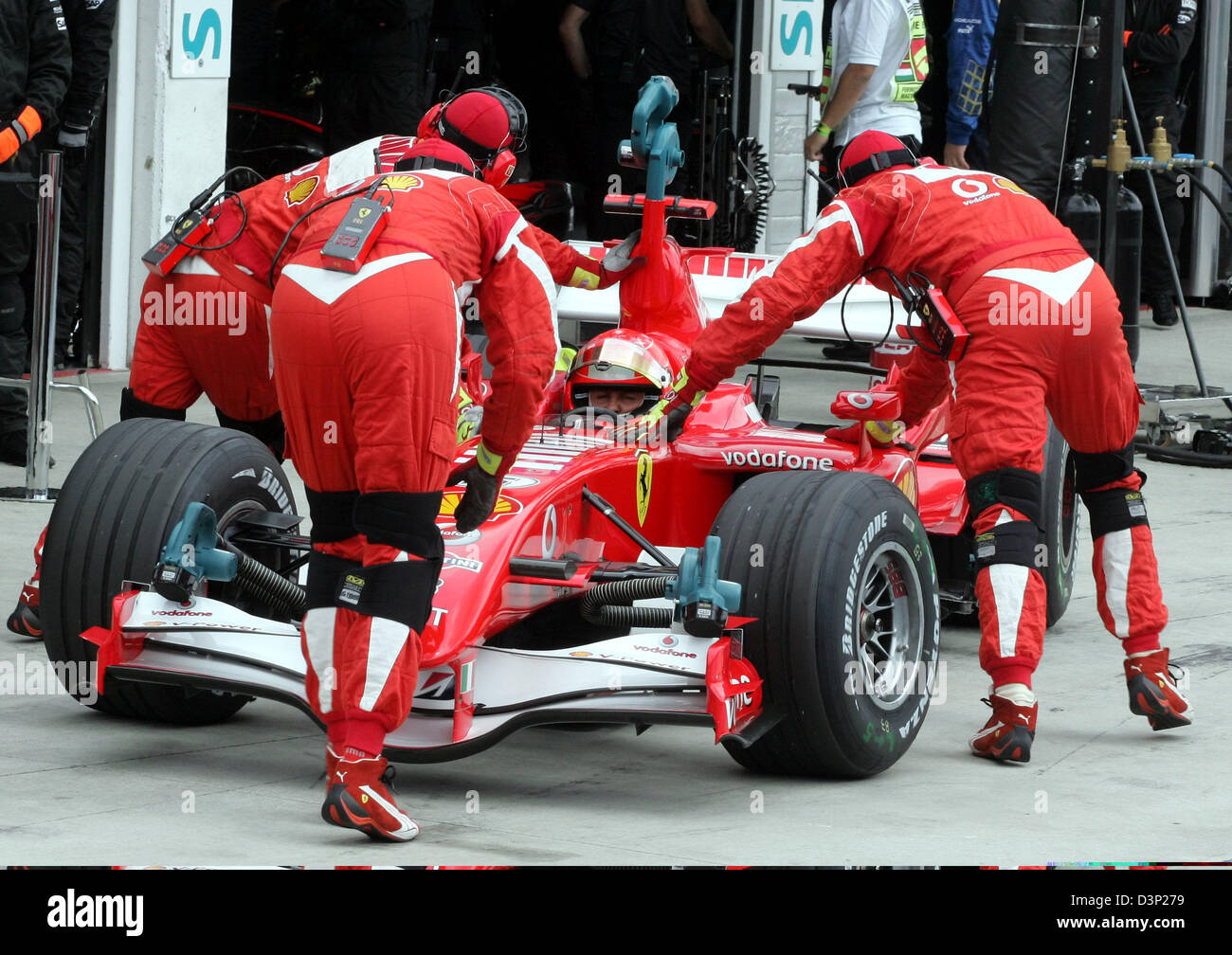 German Formula One driver Michael Schumacher of team Scuderia Ferrari and his racing car are pushed back into the garage during the third practice session of the 2006 Hungarian Grand Prix at the Hungaroring racetrack near Budapest, Hungary, Saturday, 05 August 2006. Schumacher was docked two seconds for overtaking two cars under red flags during Saturday's final practice and lost t Stock Photo