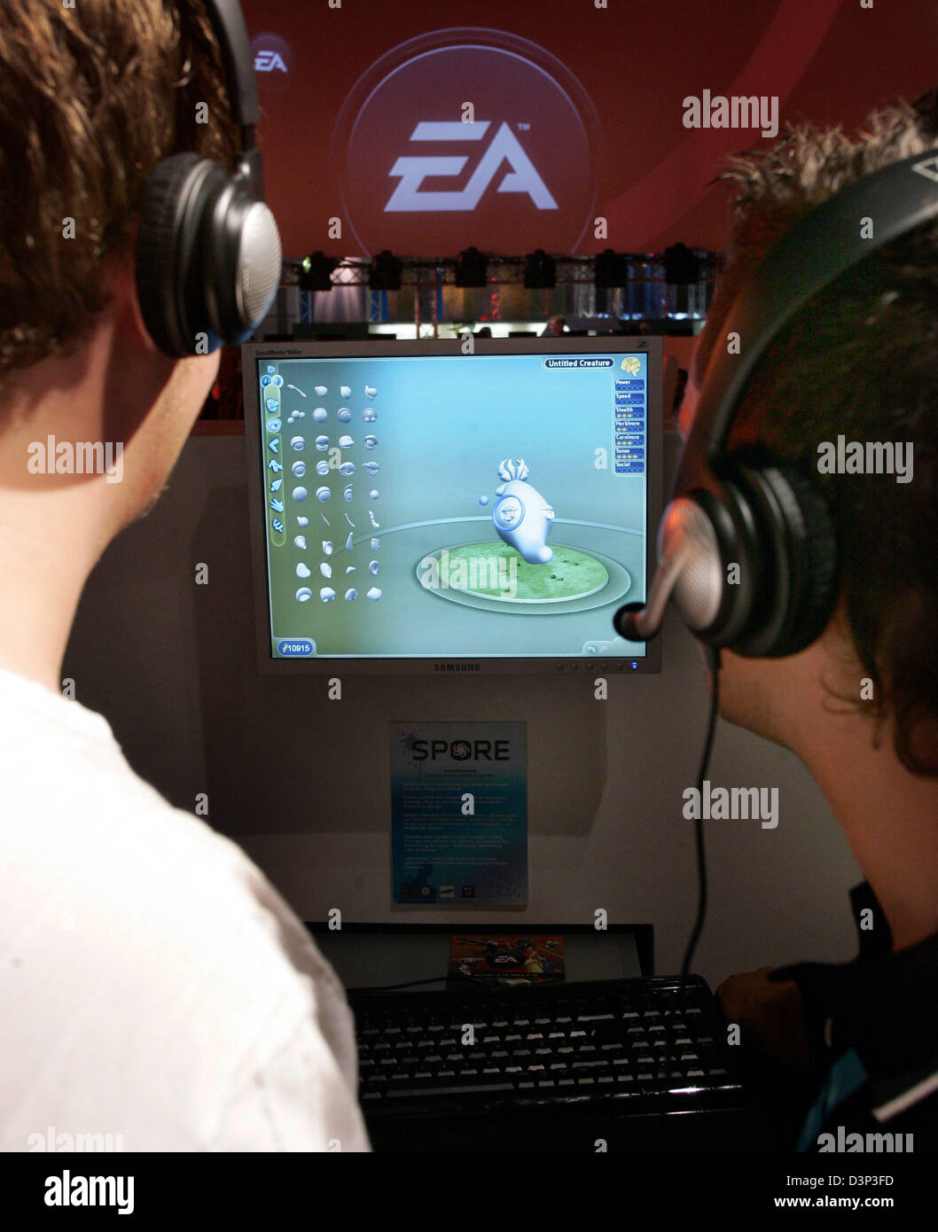The photo shows two business visitors at the stand of EA (Electronic Arts), the world's biggest producer and publisher of video games, at the trade fair 'Games Convention' in Leipzig, Germany, Wednesday, 23 August 2006.  Europe's largest trade fair for computer and video games hosts more than 400 companies presenting their newest products. About 150.000 visitors are expected to com Stock Photo