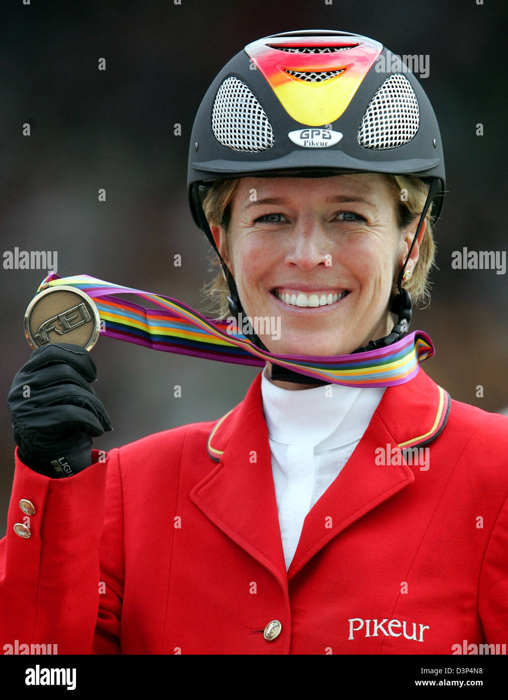German show jumper Meredith MichaelsBeerbaum cheers her bronze medal won at the Jumping