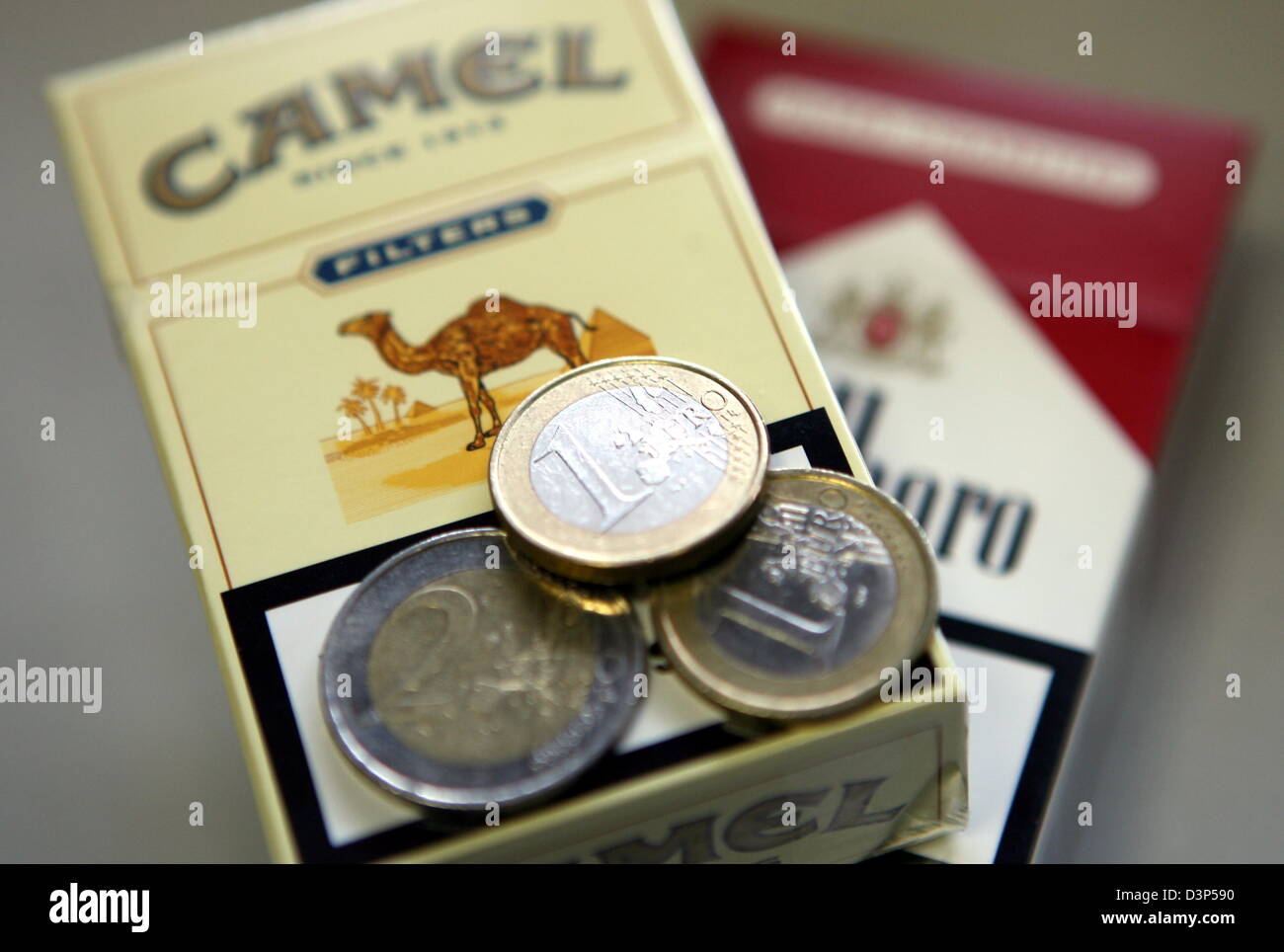 Four euros lie on top of two cigarette packets at a tobacco store in Hamburg, Germany, Wednesday 06 September 2006. Spokespersons of major tabacco companies in both Munich and Hamburg announced that smokers will pay an additional 20 cents per packet for most brands from 01 October due to a value added tax raise. A 'Marlboro' pack, with 17 cigarettes, will cost four euros. Photo: Ka Stock Photo