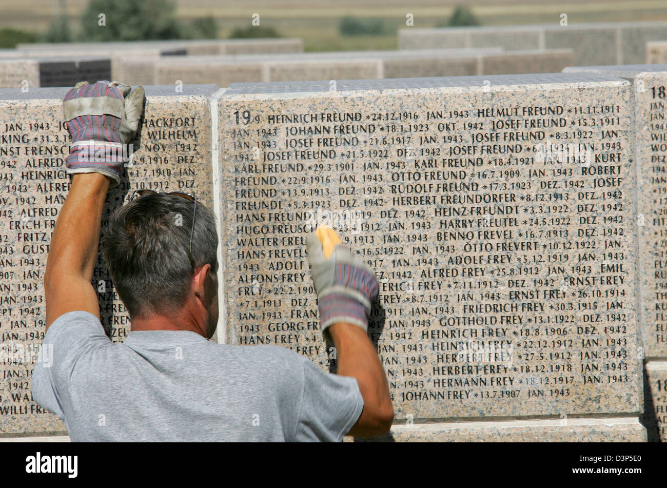 Valery Ilin cleans a granitic cube reading the names of the German WWII soldiers missing in action at the military cemetary Rossoshka near Volgograd, Russia, Friday, 08 September 2006. The names of more than 100,000 WWII soldiers missing in action since the Battle of Stalingrad are engraved to the 107 granitic cubes. The memorial place constructed by the German war graves agency 'V Stock Photo