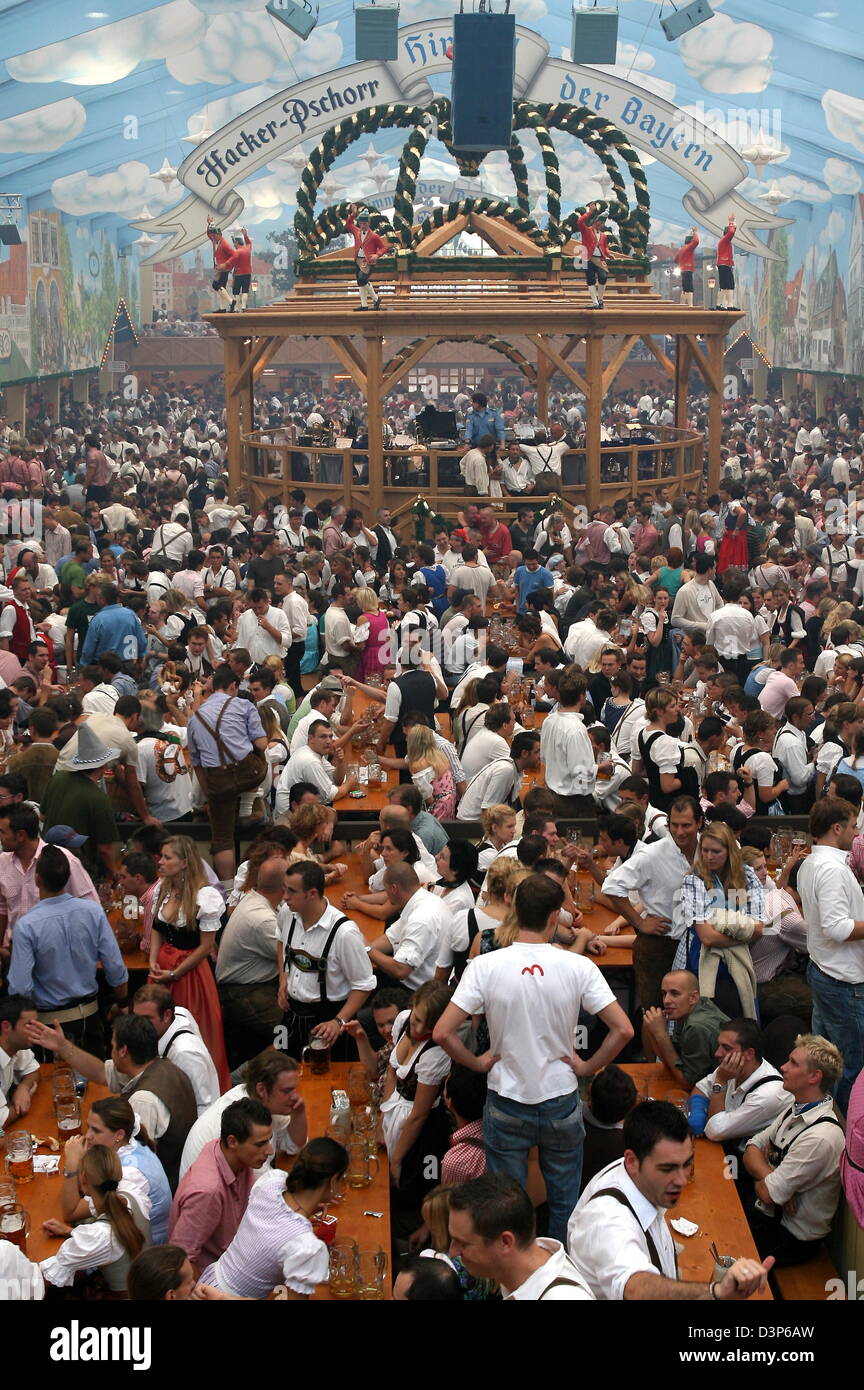 'Visitors celebrate at the Hacker Beer pavilion during  the 173rd 'Oktoberfest', the Munich Beer Festival, in Munich, Germany, Saturday 16 September 2006. The world's largest folk festival is expected to attract more than 6 million visitors in the next 18 days. Photo: Frank Leonhardt Stock Photo