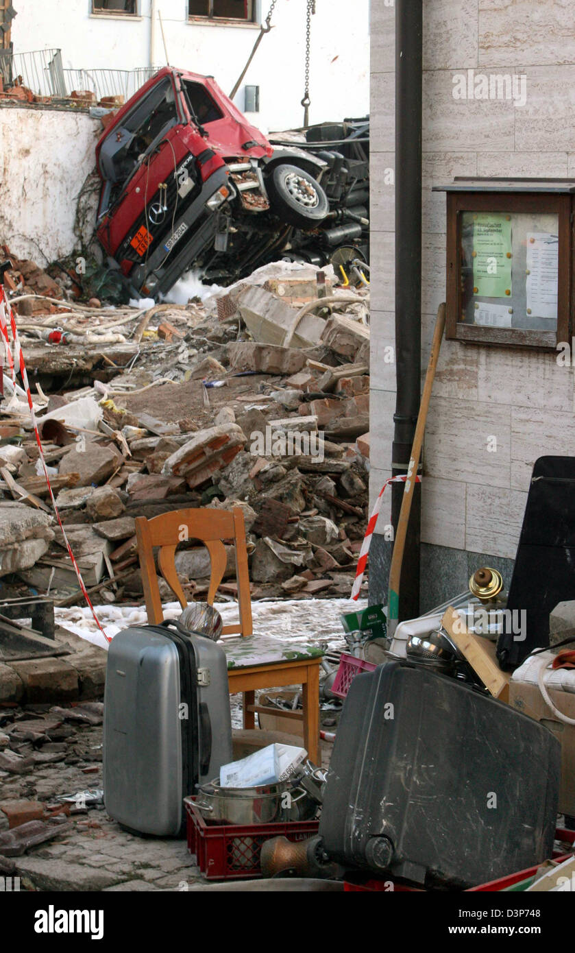 The picture shows a destroyed gas truck and household effects in the ...