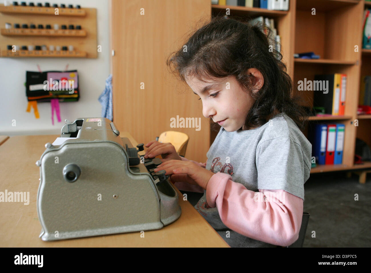 (dpa file) A blind students writes braille with a braille machine in