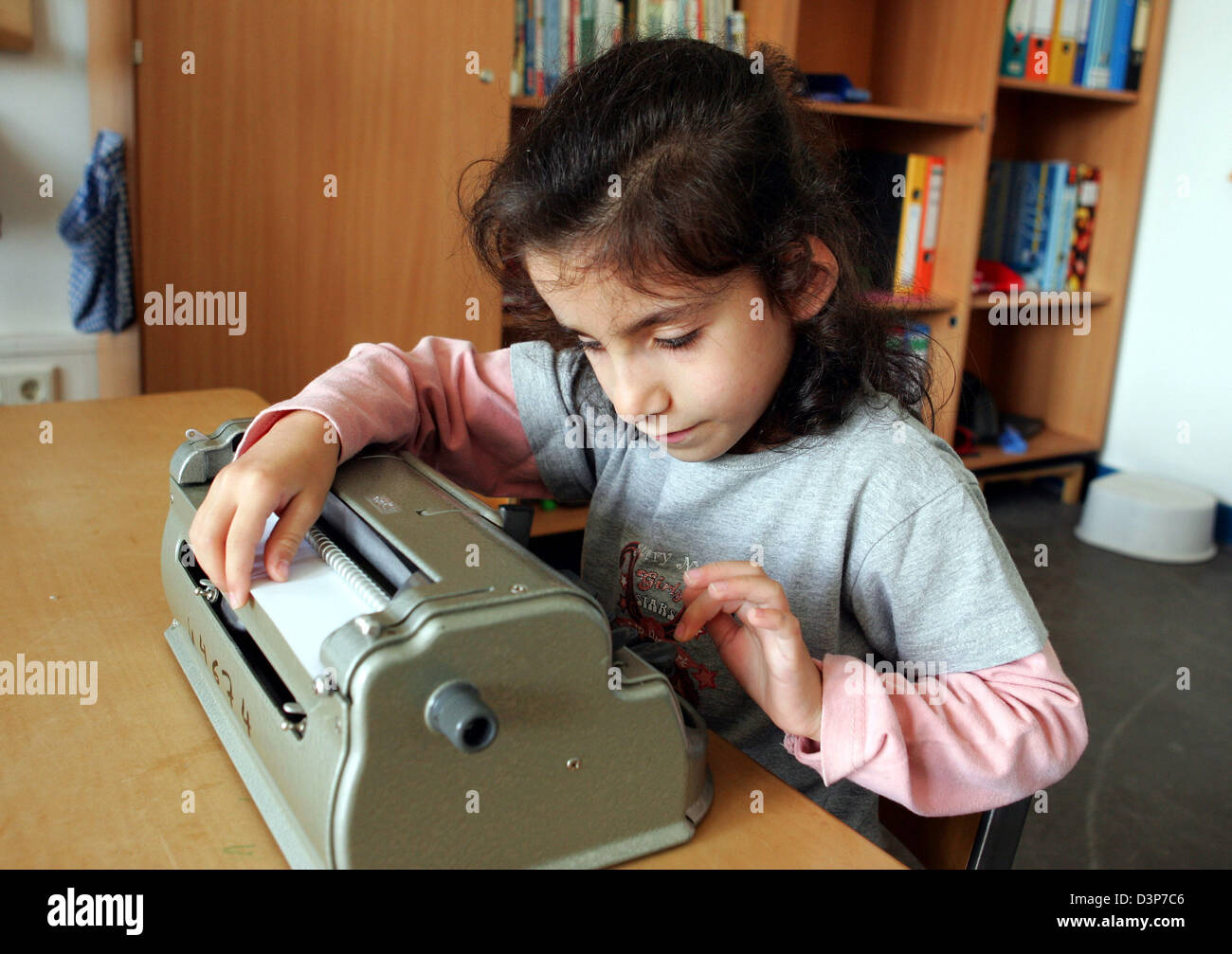 (dpa file) A blind student writes braille with a braille machine in