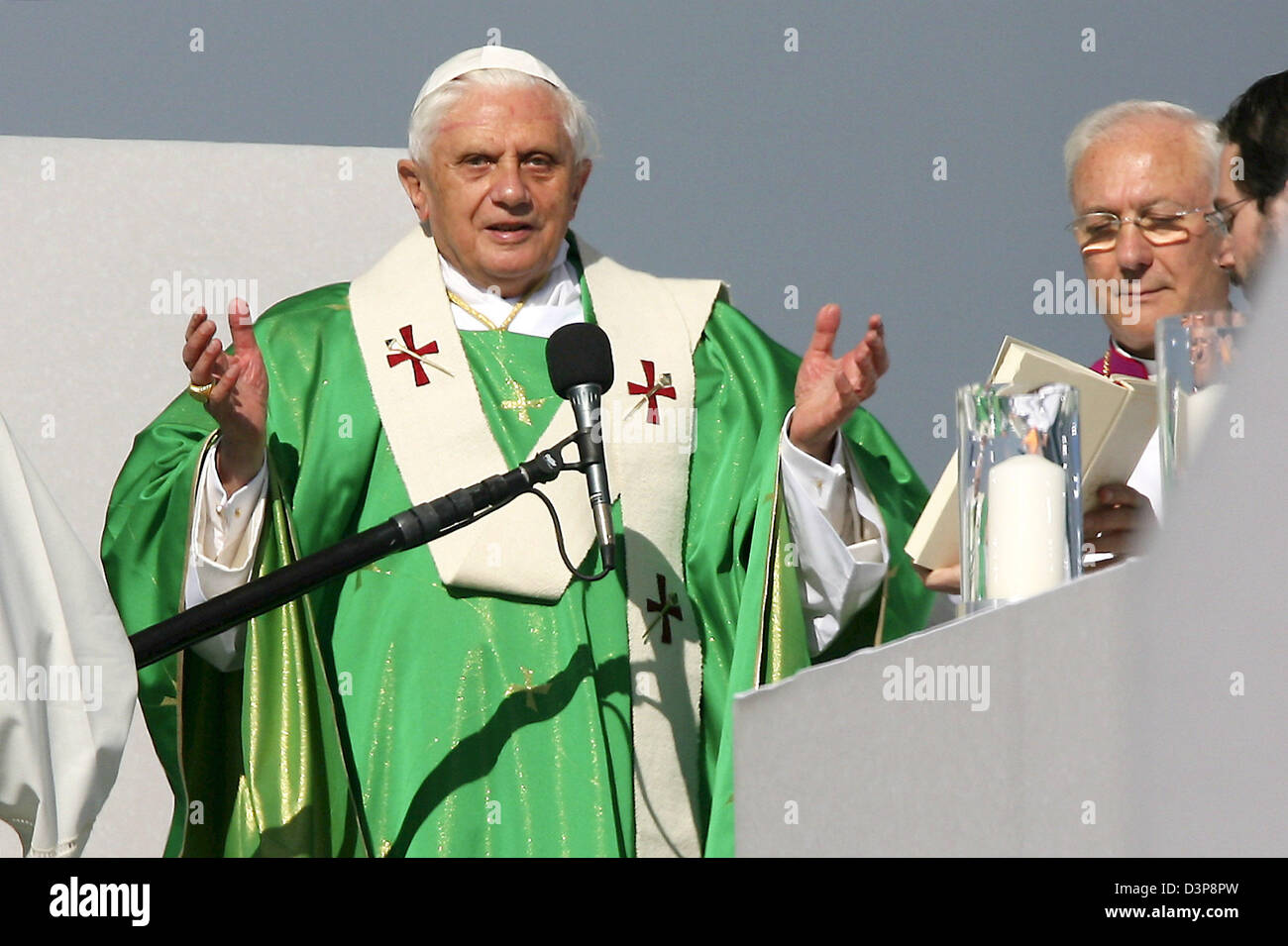 Pope Benedict XVI shown on the altar stage with spreaded arms during