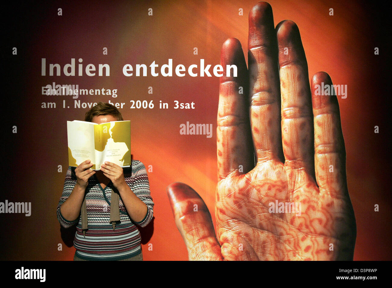 A woman is pictured reading a book at the 58th International Frankfurt Book Fair 2006 in Frankfurt Main, Germany, Tuesday, 03 October 2006. The fair is the world's most important book fair and anyone in the industry will be there: authors and publishers, booksellers and librarians, art dealers and illustrators, agents and journalists, information brokers and readers. Not only is th Stock Photo