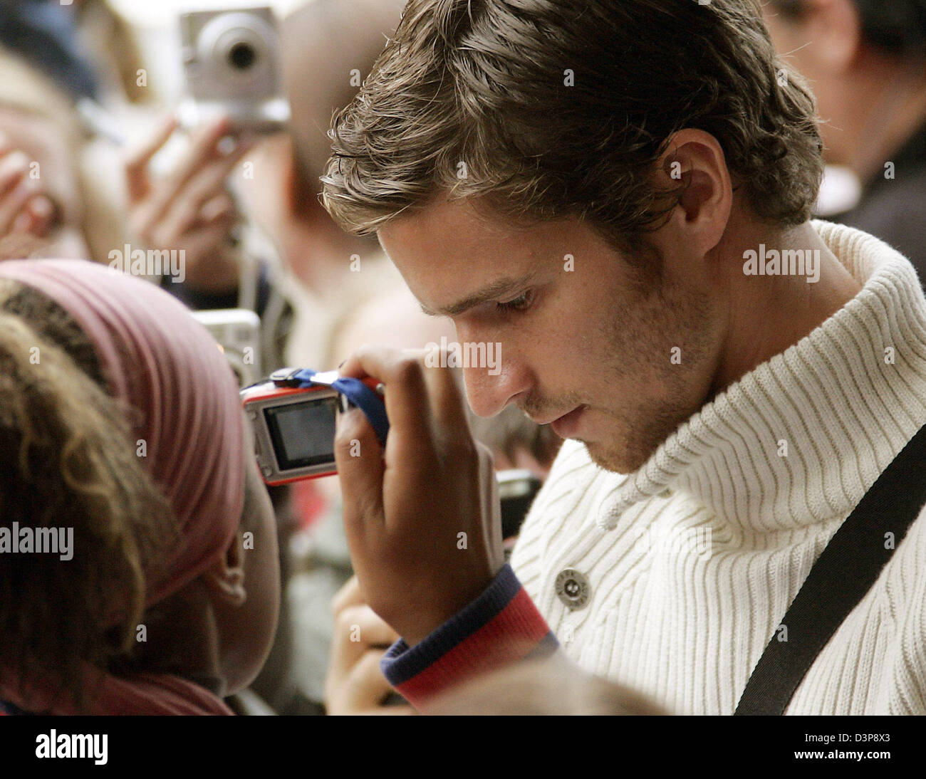 Player of the German national soccer team Arne Friedrich signs autographs prior to the premiere of the film 'Deutschland - Ein Sommermaerchen' ('Germany - A summer dream') at the Berlinale film palace in Berlin, Germany,  Tuesday, 03 October 2006. The film recalls the story of the German soccer national team during the 2006 FIFA World Cup. The film will be shown in German cinemas s Stock Photo